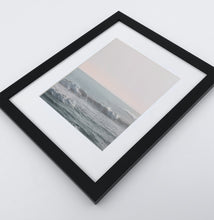 Load image into Gallery viewer, Big fluffy ocean waves in a light pink sunrise sky photo print in a black frame