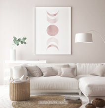 Load image into Gallery viewer, White-Framed Moon Phases Watercolor Print in Bage and Brown on a living room wall