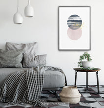 Load image into Gallery viewer, Black-framed Navy and pink Jupiter-like abstract wall art in a bedroom