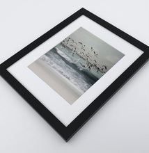 Load image into Gallery viewer, A framed print with seagulls flying above the ocean shore