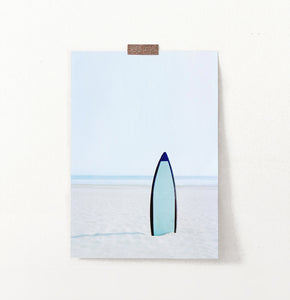 Blue Surfboard Stuck Upright in the Sand Wall Art