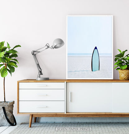Blue Surfboard Stuck Upright in the Sand Wall Art