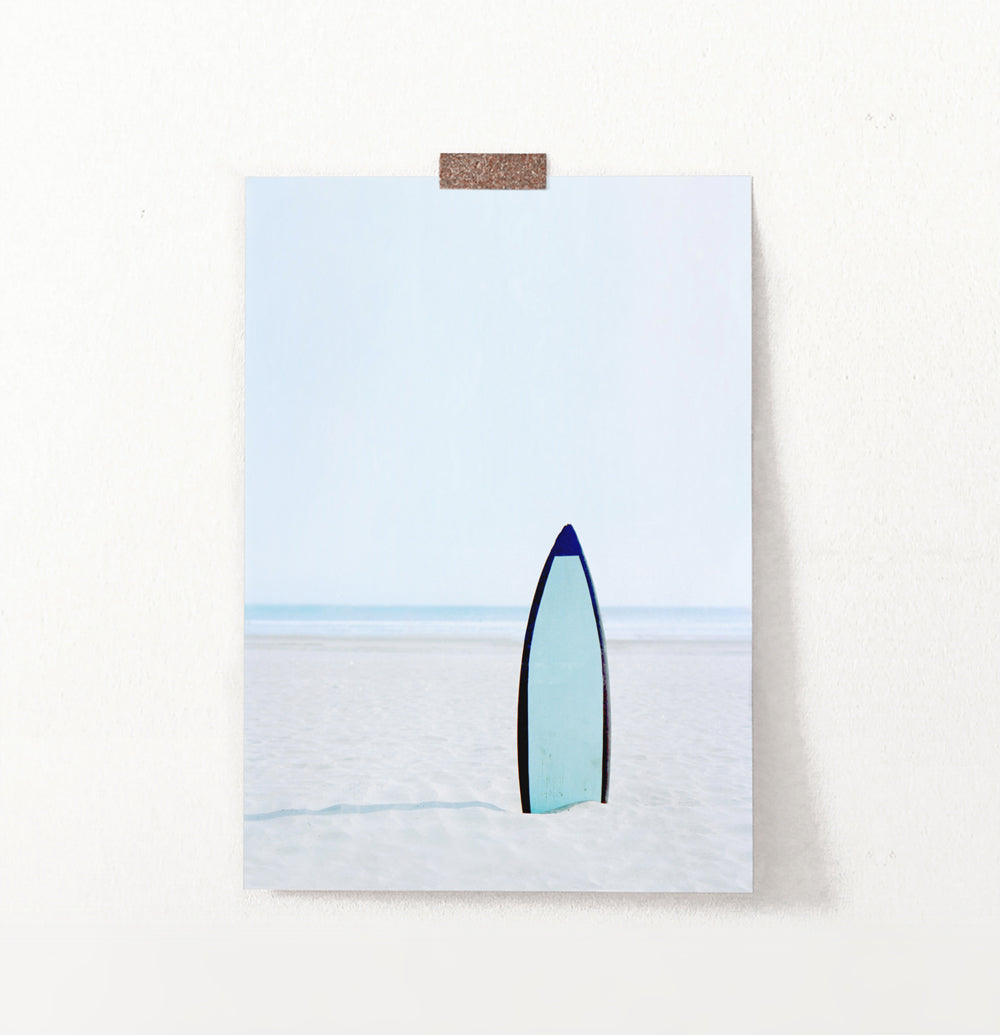 Blue Surfboard Stuck Upright in the Sand Wall Art