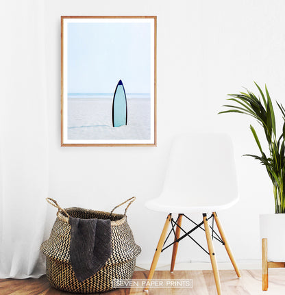 Blue Surfboard Stuck Upright in the Sand Wall Art