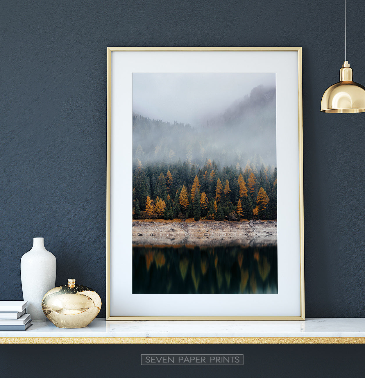 Golden-framed on a white marble shelf