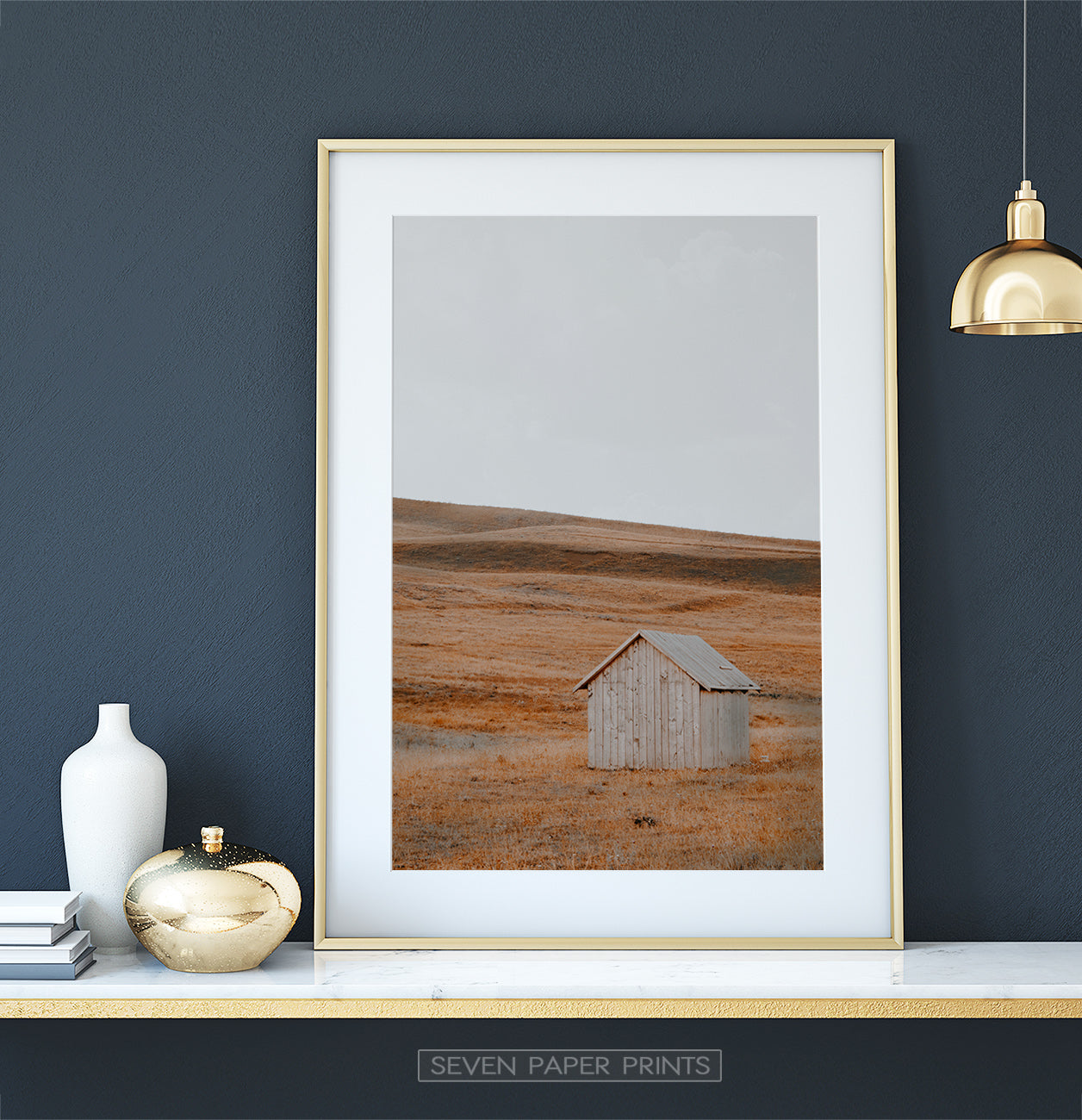 Golden-framed on a white&gold marble shelf
