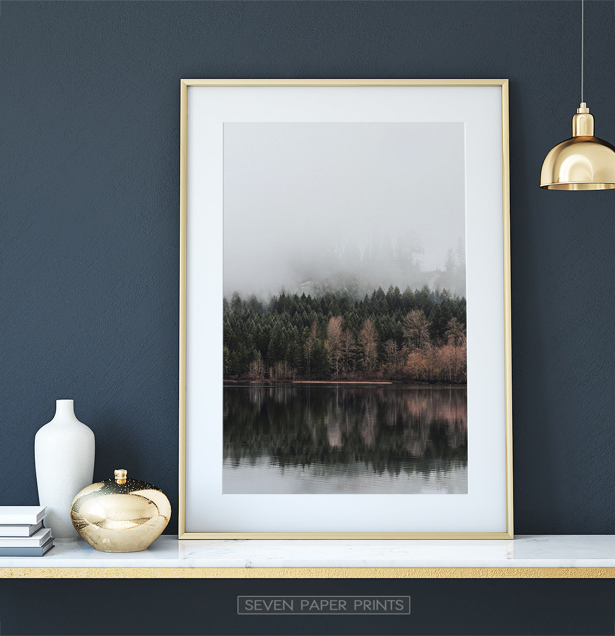 Golden-framed on a white marble shelf