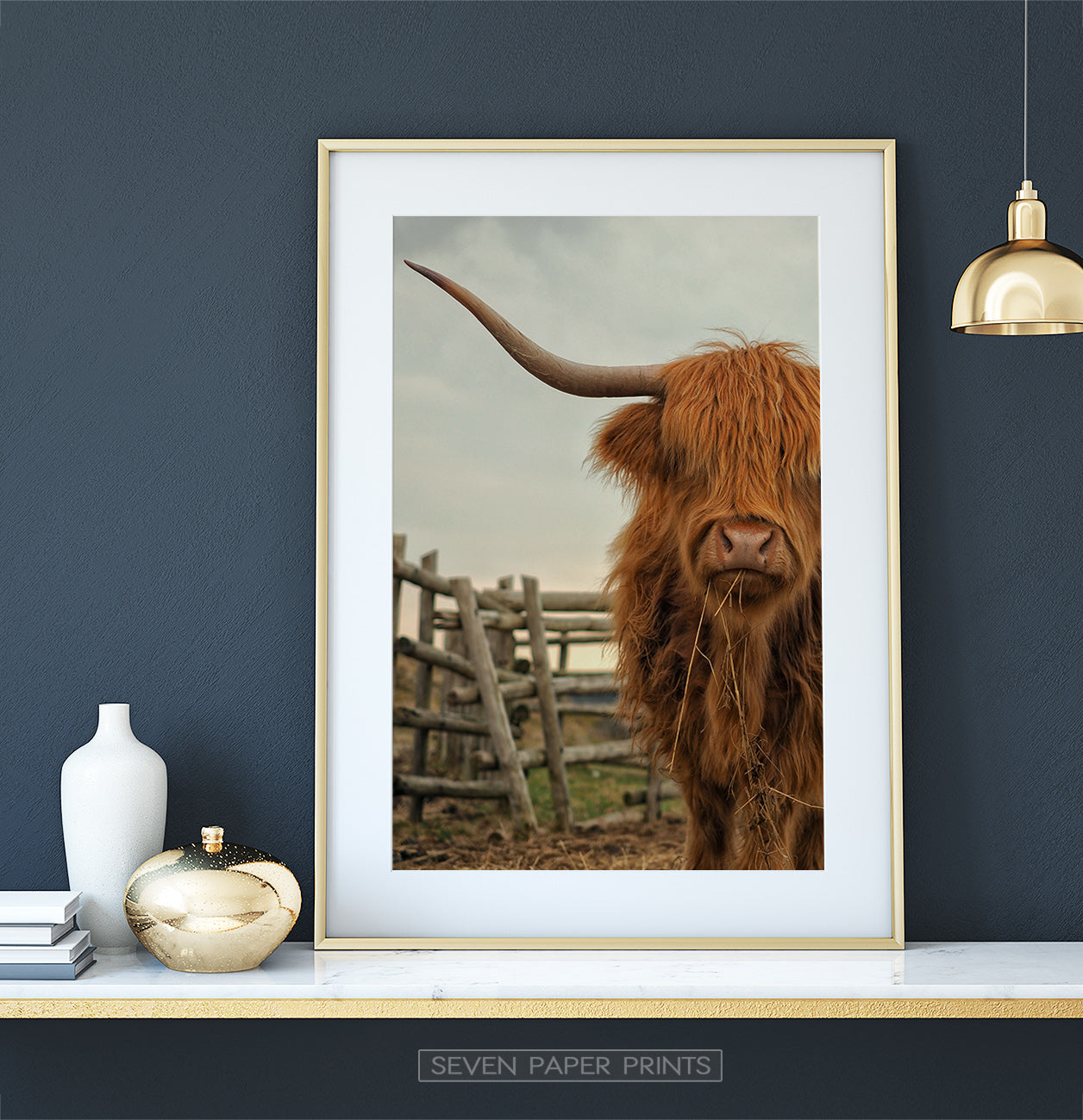 Golden-framed on a white&gold marble shelf