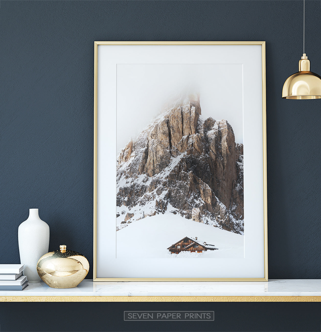 Gold-framed Snowy House Under A Cliff In The Mountains Wall Art
