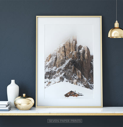 Gold-framed Snowy House Under A Cliff In The Mountains Wall Art