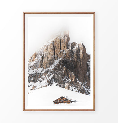Wooden-framed Snowy House Under A Cliff In The Mountains Wall Art