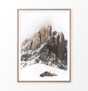 Wooden-framed Snowy House Under A Cliff In The Mountains Wall Art
