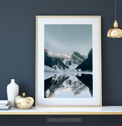 Golden-framed on a white marble shelf