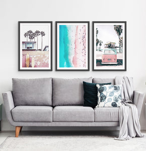 Three photo prints of California beach house, surfing boards, a coast and a surfing miniwan in white frames