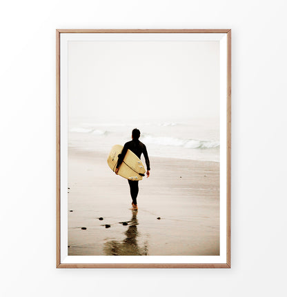 Surfer with yellow surfboard walking toward ocean