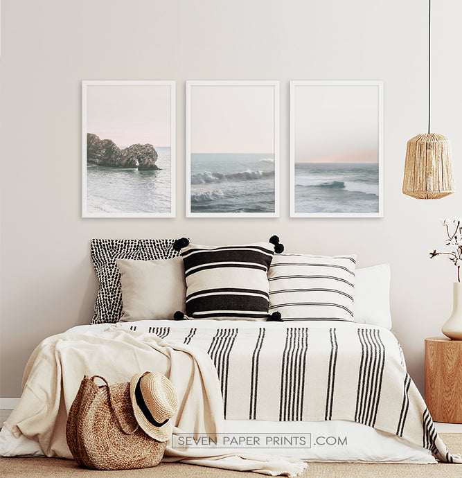 Three ocean photos in frames on a bedroom wall