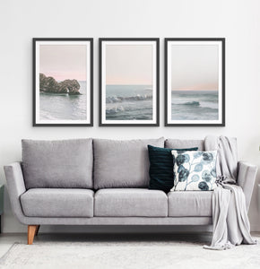Three ocean photos in frames on a living room wall