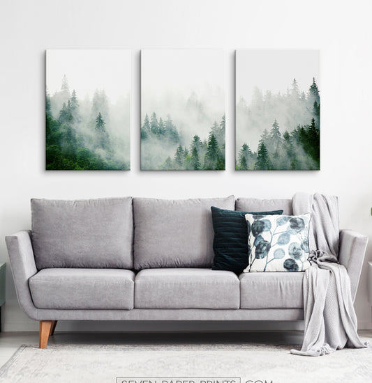 Three misty forest photo prints hanging on wall above the big living room sofa