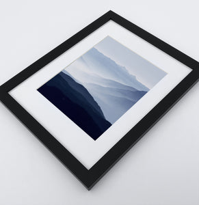 A Framed Print of a Foggy Mountain Landscape 3