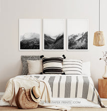 Load image into Gallery viewer, 3 posters of black and white foggy mountain landscapes above a bed
