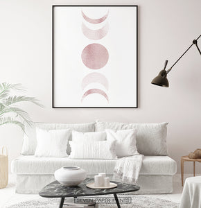 Black-Framed Moon Phases Watercolor Print in Bage and Brown on a living room wall