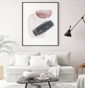 Black-Framed Handpainted Watercolor Print with Beige, Black and Brown on a living room wall