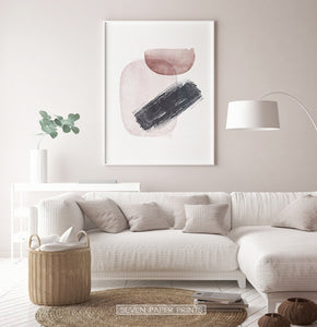 White-Framed Handpainted Watercolor Print with Beige, Black and Brown on a living room wall