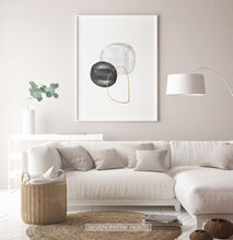 Load image into Gallery viewer, A white-framed wall art with black, silver and golden forms in a living room
