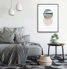Load image into Gallery viewer, Black-framed Navy and pink Jupiter-like abstract wall art in a bedroom

