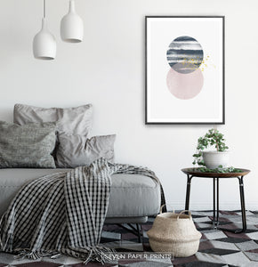 Black-framed Navy and pink Jupiter-like abstract wall art in a bedroom
