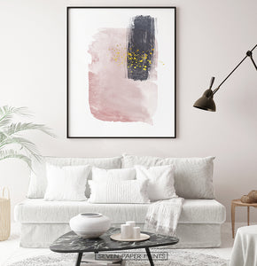 Black-framed Pink and Powder stains under gold drops wall art in a living room