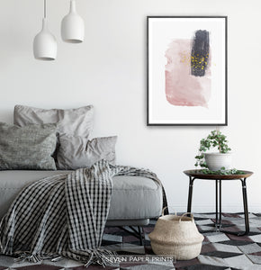 Black-framed Pink and Powder stains under gold drops wall art in a bedroom
