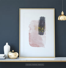 Load image into Gallery viewer, Gold-framed Pink and Powder stains under gold drops wall art on a shelf
