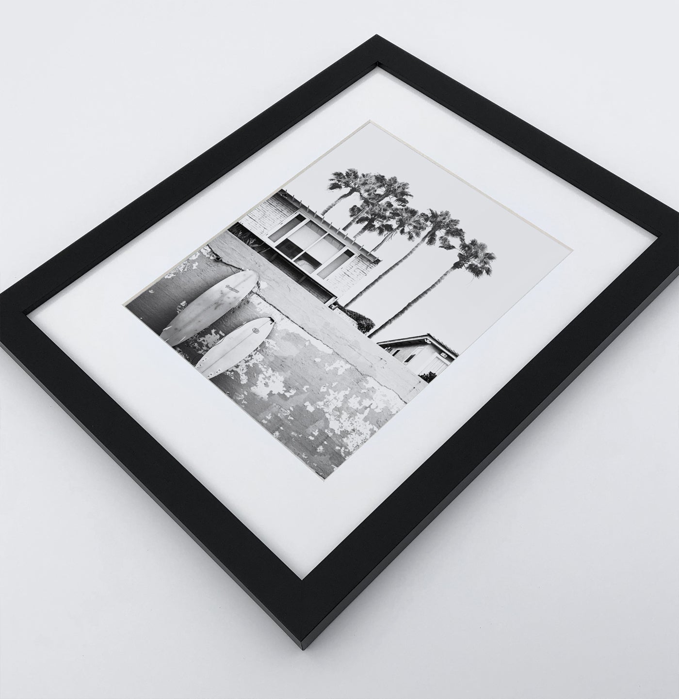 A boat coastal house with surfing boards in a black frame