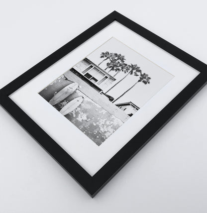 A boat coastal house with surfing boards in a black frame