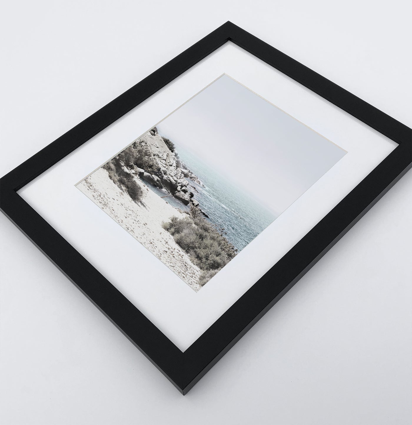 A white shore of the ocean photo in a black frame
