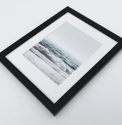 A white shore of the ocean photo in a black frame