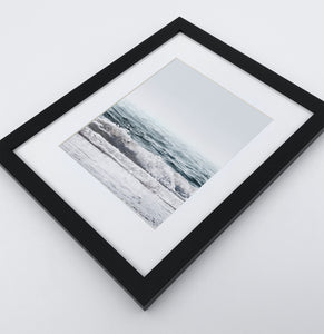 A white shore of the ocean photo in a black frame