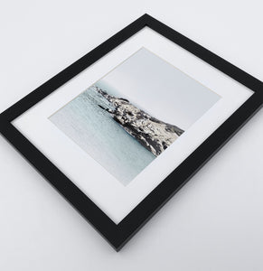 A white shore of the ocean photo in a black frame
