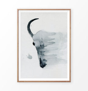 A smudged bull skull watercolor painting print in a frame