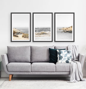 Three photo prints of sandy ocean shore in natural colors in black frames