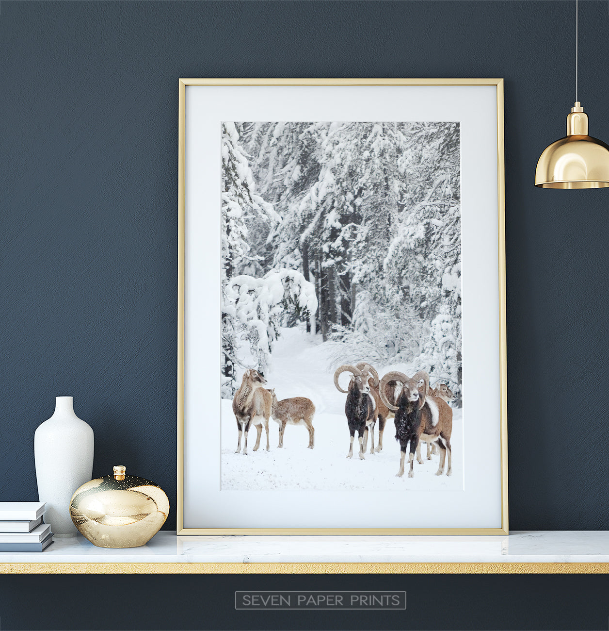 Golden-framed on a white marble shelf