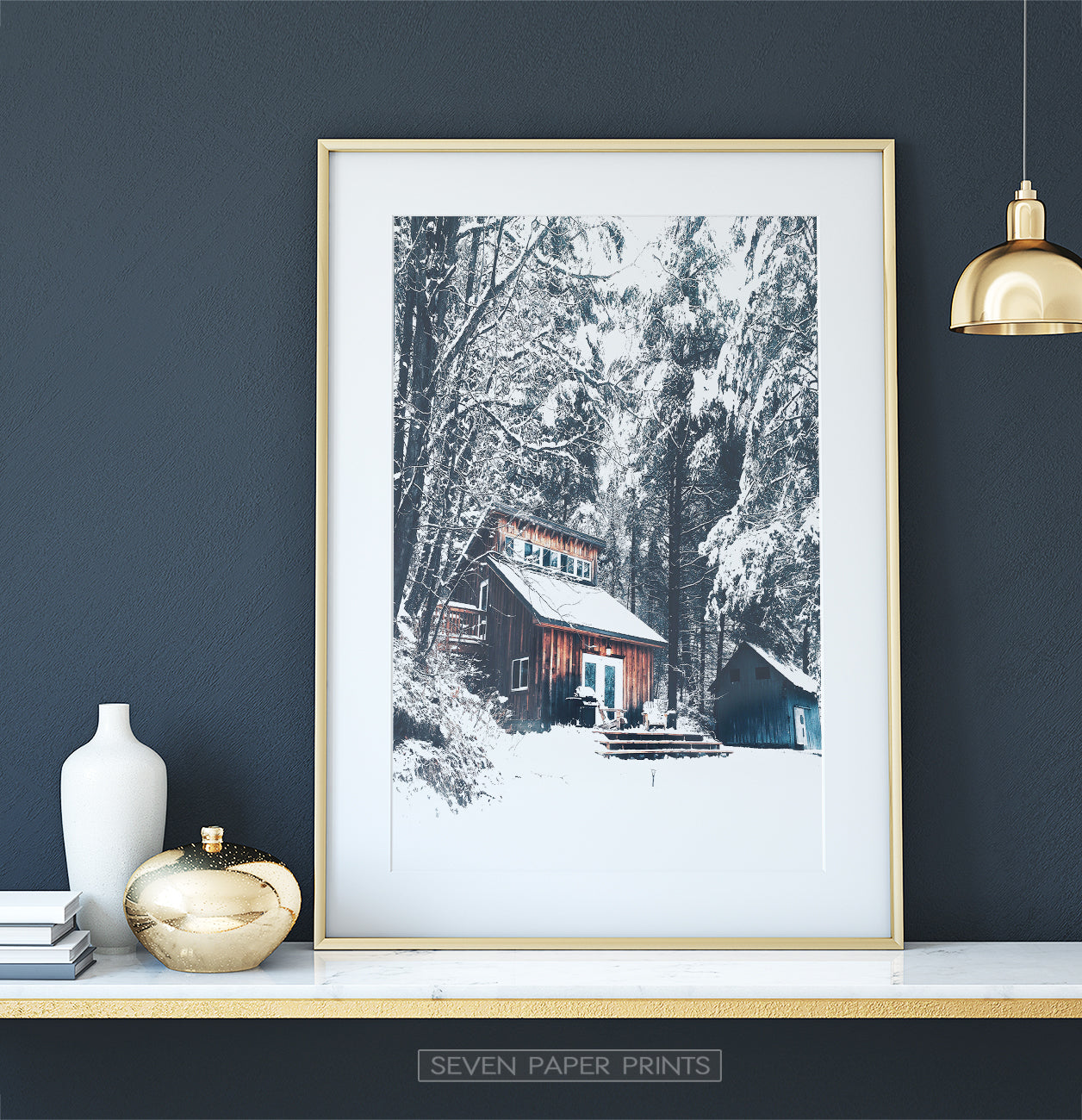 Golden-framed on a white marble shelf