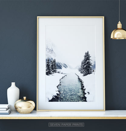 Golden-framed on a white marble shelf