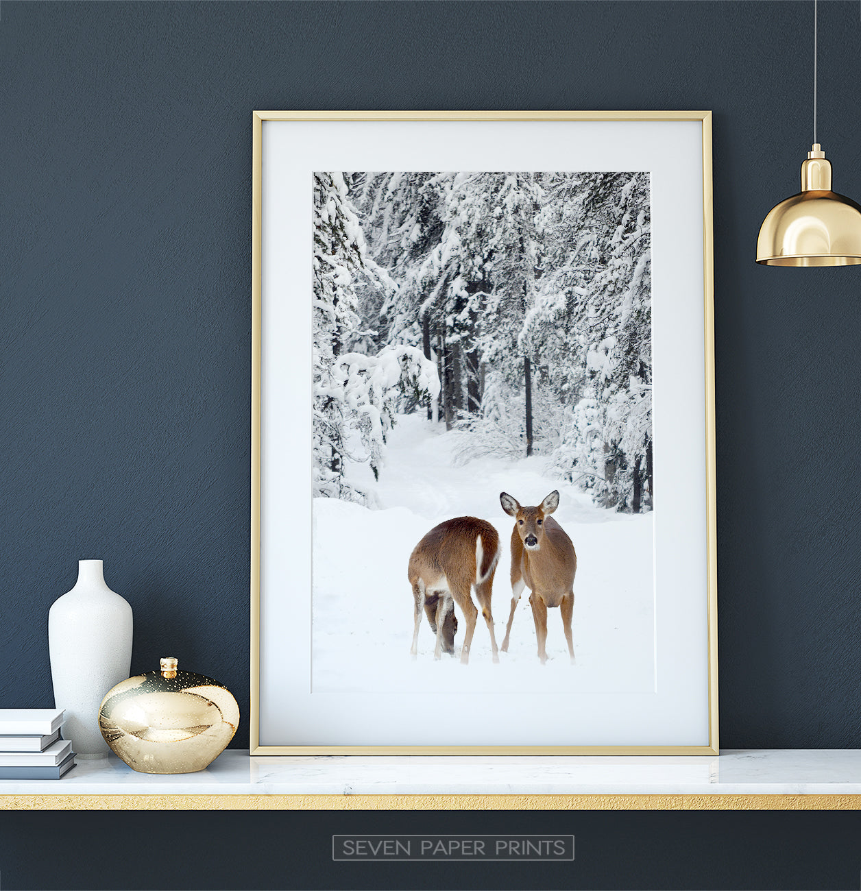 Golden-framed on white marble shelf