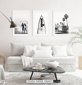 Black and white wall art set in light room with sofa