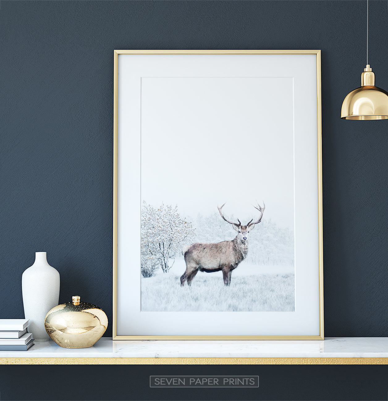 Gold-framed on white marble shelf