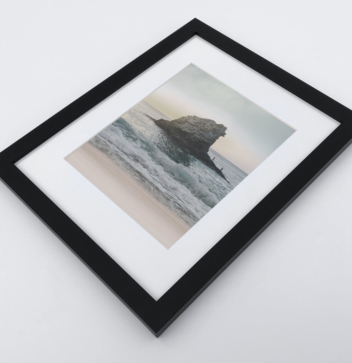 A framed print with rock in a stormy ocean