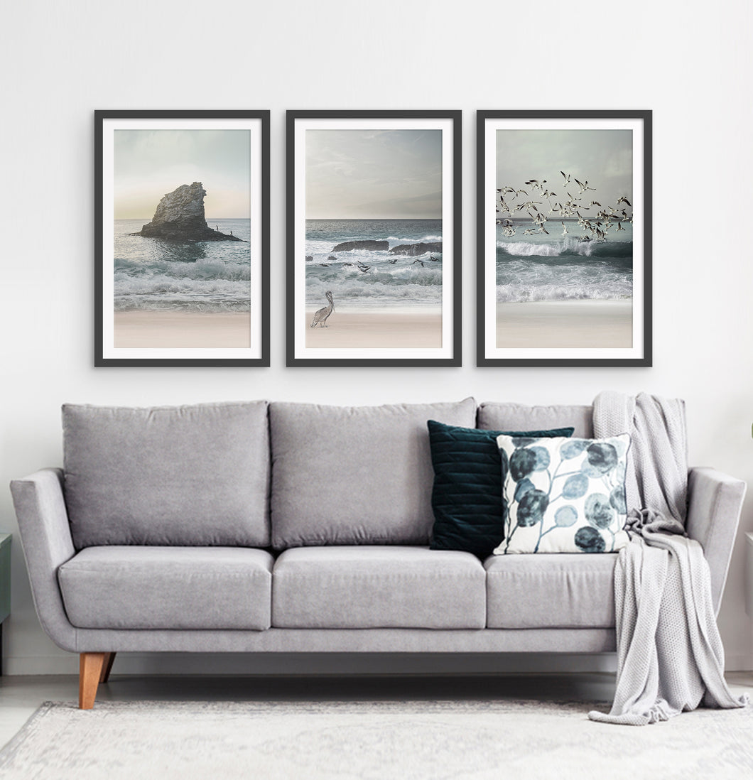 Three framed prints with a stormy ocean landscape