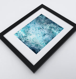 A detailed arial ocean waves photo in a dark frame